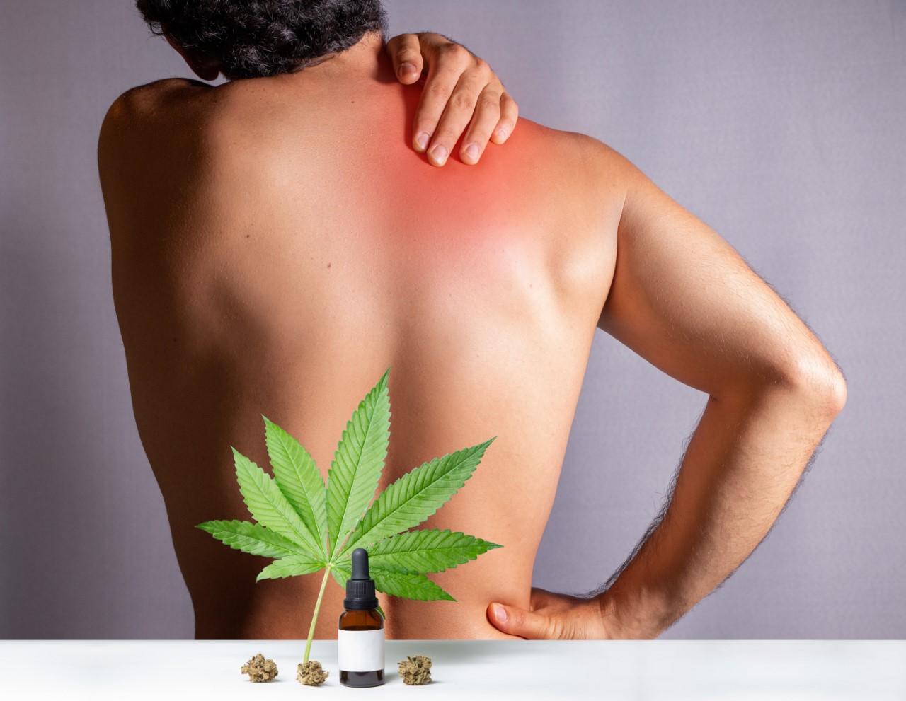 Man without shirt rubbing red spot on shoulder with Cannabis leaf imposed.