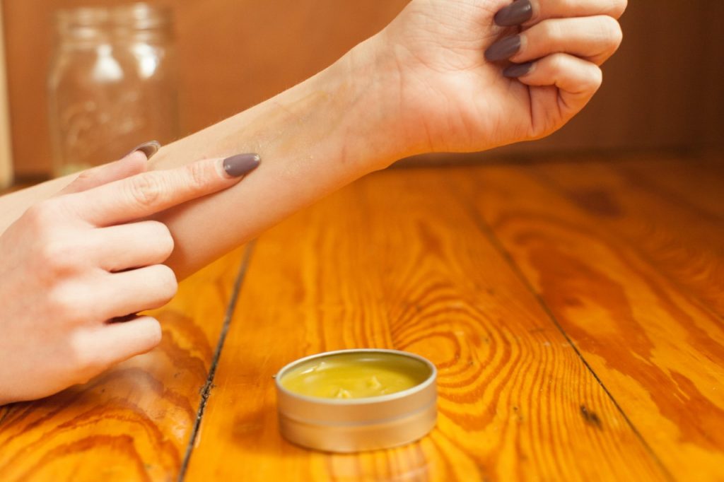 Woman applying CBD Topical cream to her wrist.