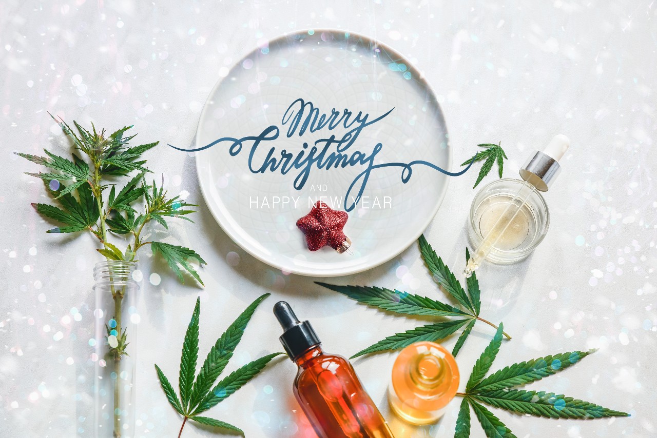 Happy Holidays banner with Cannabis leaves surrounding a dinner plate.
