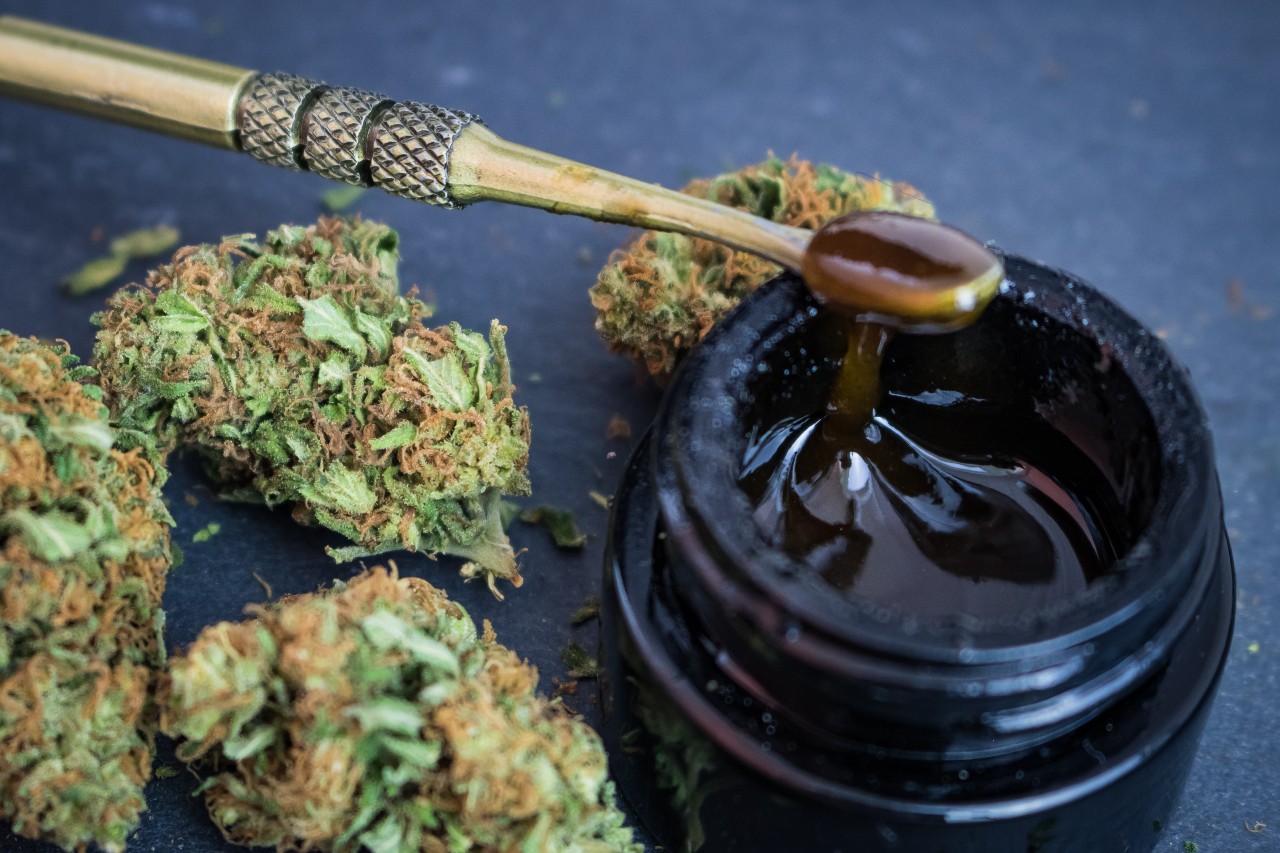 Dabbing Tool with Cannabis Butter and Cannabis Flower on table